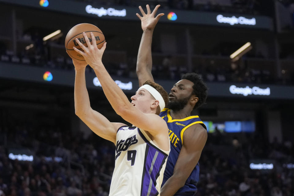 Sacramento Kings guard Kevin Huerter (9) shoots against Golden State Warriors forward Andrew Wiggins during the first half of an NBA basketball game in San Francisco, Wednesday, Nov. 1, 2023. (AP Photo/Jeff Chiu)