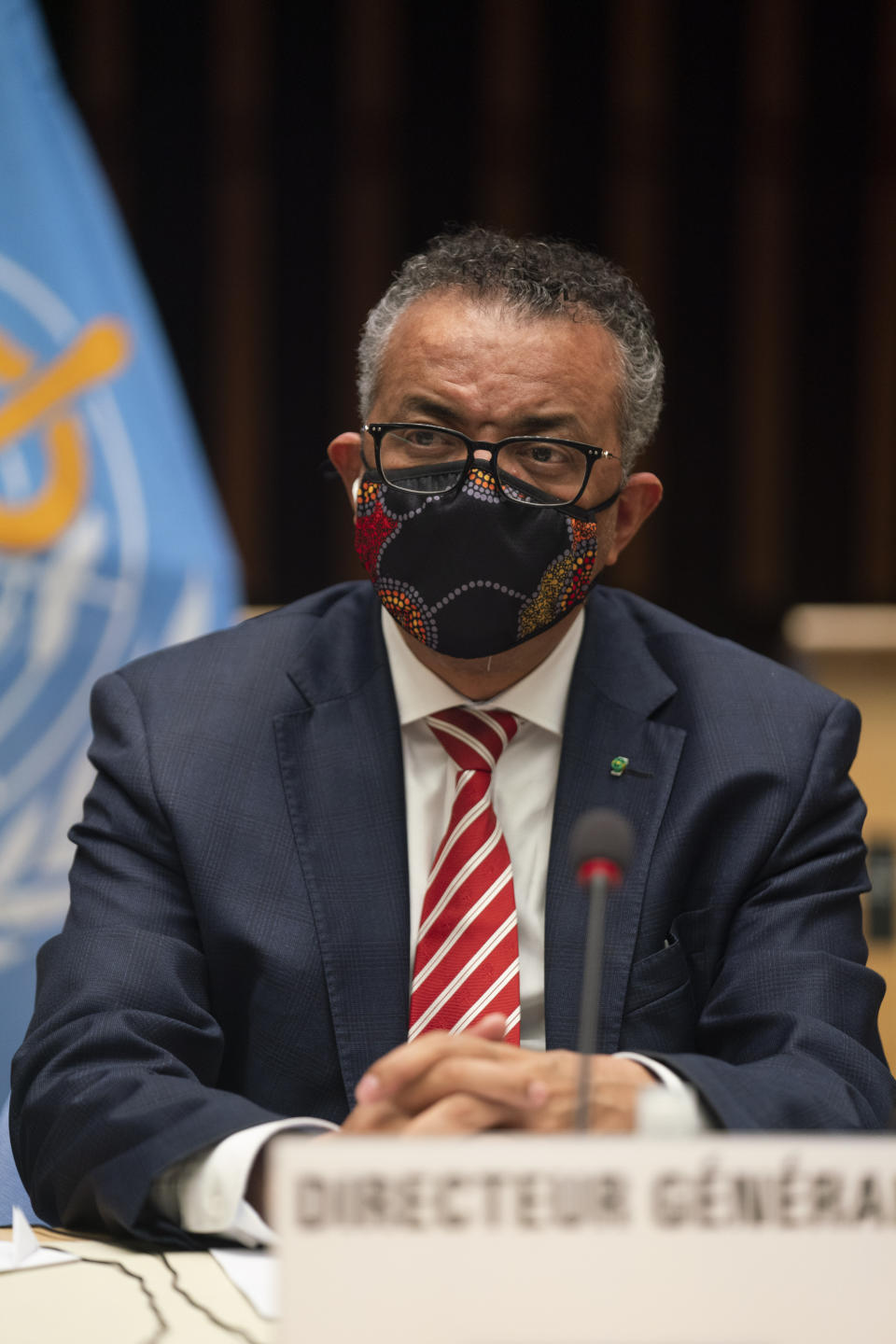 In this photo released by WHO, World Health Organisation on Monday, Oct. 5, 2020, WHO Director-General, Dr Tedros Adhanom Ghebreyesus, wearing a mask to protect against coronavirus, looks on, during a special session on the COVID-19 respnse. The head of emergencies at the World Health Organization says its “best estimates” indicate that roughly 1 in 10 people worldwide may have been infected by the coronavirus. (Christopher Black/WHO via AP)