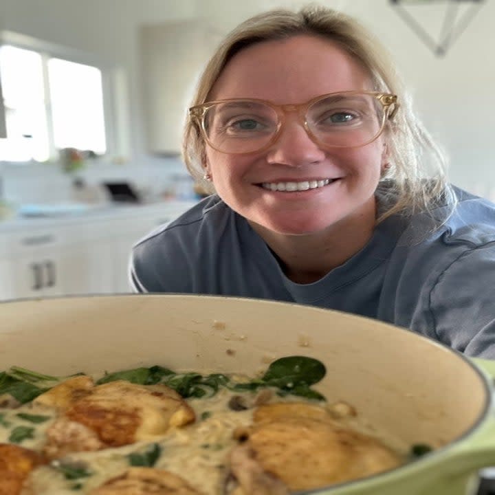 the author with a dutch oven with chicken and mushroom orzo