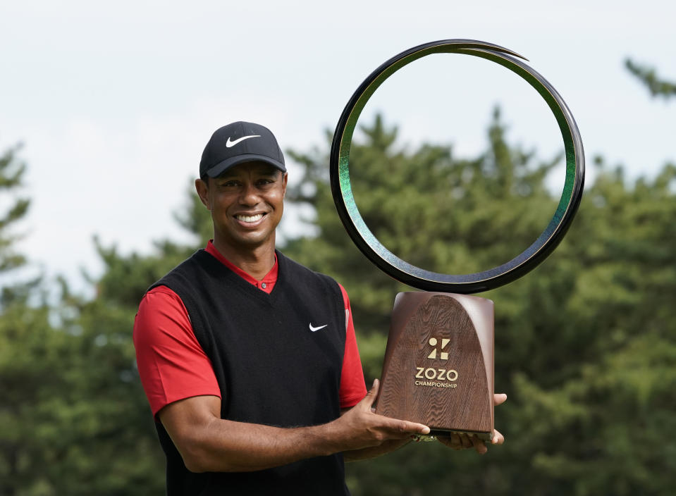 Tiger Woods of the United States poses with his trophy after winning the Zozo Championship PGA Tour at the Accordia Golf Narashino country club in Inzai, east of Tokyo, Japan, Monday, Oct. 28, 2019. (AP Photo/Lee Jin-man)