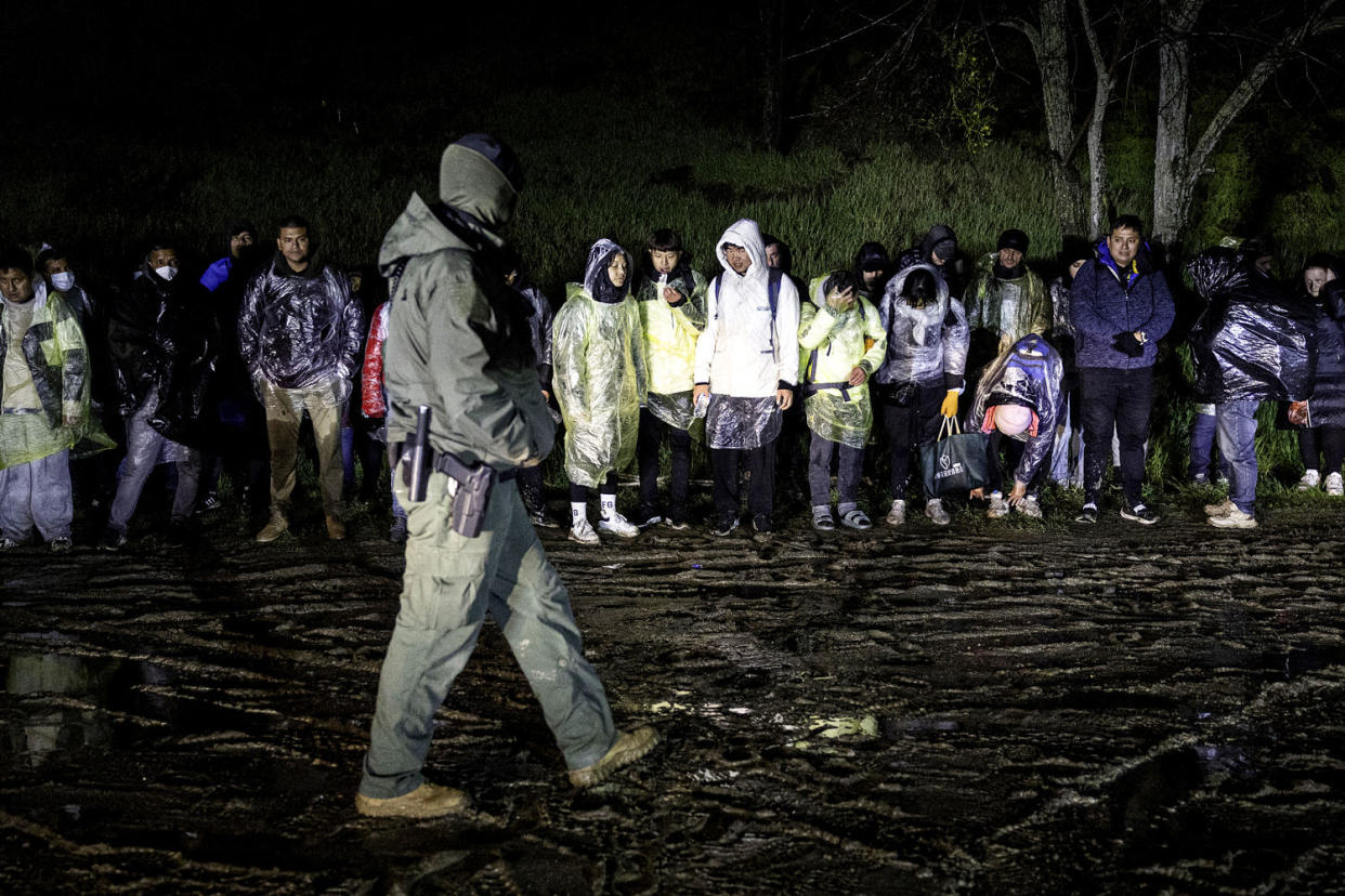 Immigrants wait to be transported by U.S. Border Patrol agents. (John Moore / Getty Images file)