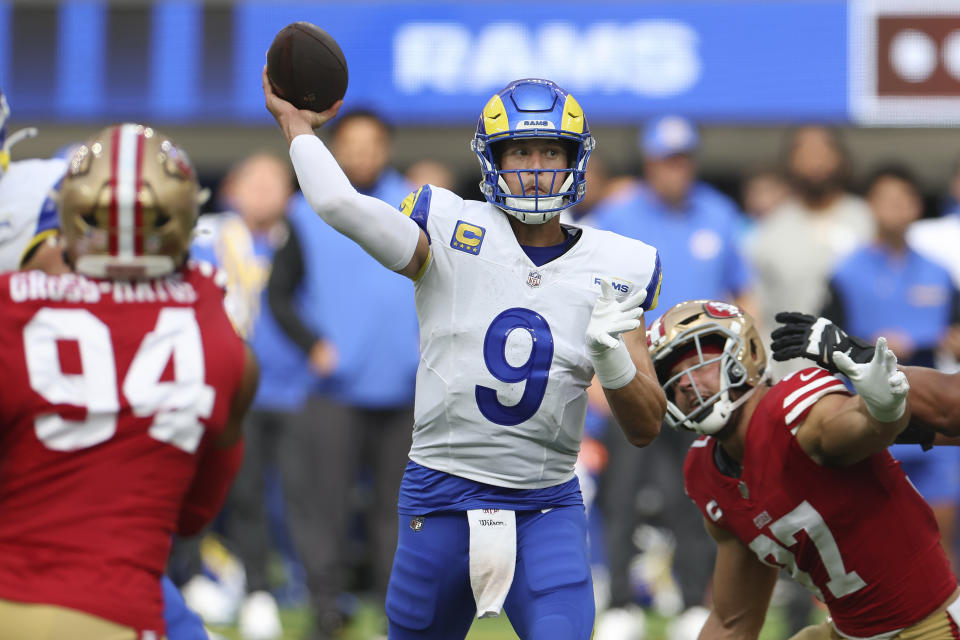 Los Angeles Rams quarterback Matthew Stafford (9) passes between San Francisco 49ers defensive end Yetur Gross-Matos (94) and defensive end Nick Bosa during the first half of an NFL football game, Sunday, Sept. 22, 2024, in Inglewood, Calif. (AP Photo/Ryan Sun)