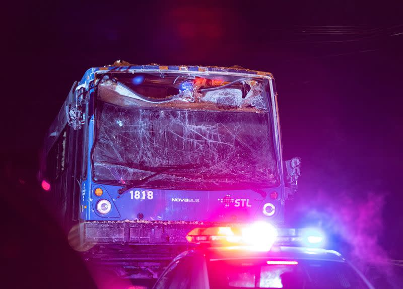 A Laval city bus is towed away after being pulled out of the daycare facility it crashed into in Laval, Quebec