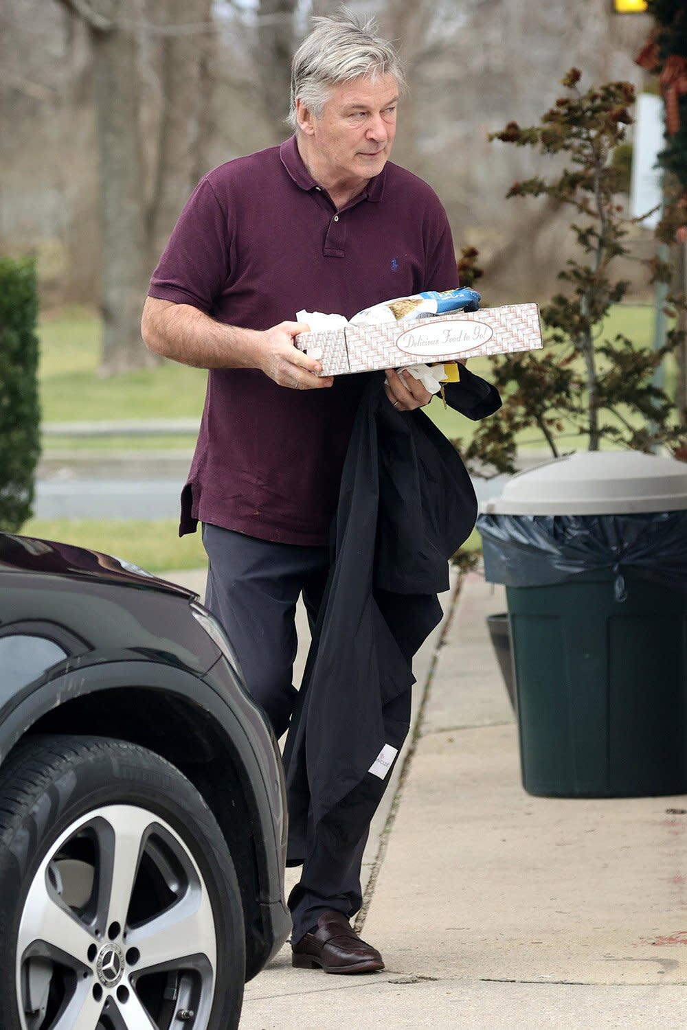 Despite recent charges of involuntary manslaughter, Alec Baldwin appeared to be carrying on with his daily routine as he was seen in East Hampton, New York today. The actor was photographed looking relaxed as he picked up a takeout meal from a local restaurant, dressed in a navy Ralph Lauren Polo shirt, black pants, and formal shoes.