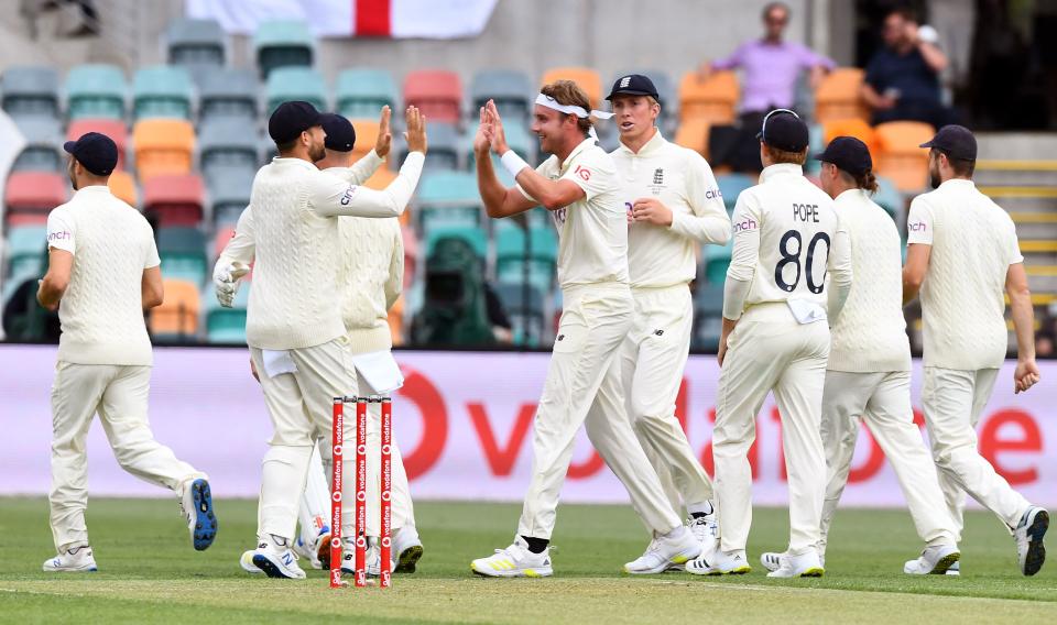 Stuart Broad (pictured middle) celebrates with teammates after dismissing Australian batsman Usman Khawaja.