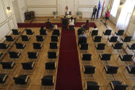 Groom Gyorgy David Jablonovszky and his bride Timea Jablonovszky attend their wedding ceremony along with their family members at the town hall of Miskolc, Hungary, Saturday, March 28, 2020. The couple celebrate today without wedding guests because of the government regulations to prevent the COVID-19 coronavirus pandemic. The new coronavirus causes mild or moderate symptoms for most people, but for some, especially older adults and people with existing health problems, it can cause more severe illness or death. (Janos Vajda/MTI via AP)