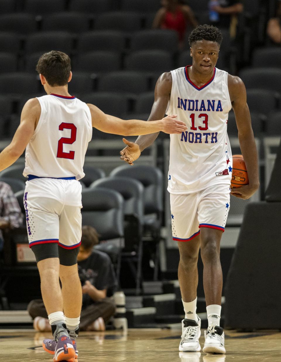 North Future All-Star Flory Bidunga (13), a junior from Kokomo High School, reacts after being fouled with teammate Trey Buchanan (2), a junior from Westfield High School, during the second half of an boysâ€™ Indiana High School Future All-Stars basketball game, Saturday, June 10, 2023, at Gainbridge Fieldhouse, in Indianapolis.