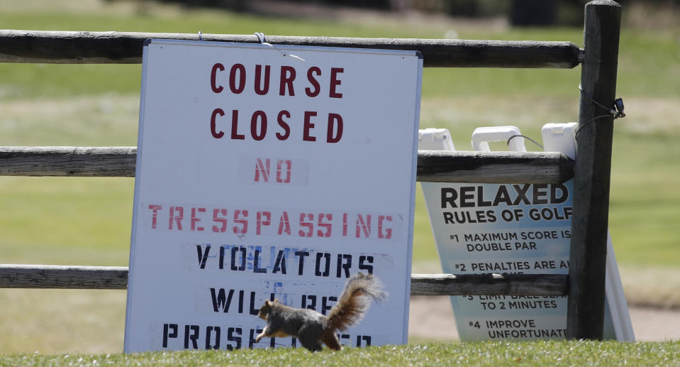 A squirrel runs past the sign outside Harvard Gulch Municipal Golf Course after it, along with other city-owned courses and parks, were closed until Friday, April 10, to group activities in an effort to reduce the spread of the new coronavirus Tuesday, March 24, 2020, in Denver. According to the World Health Organization, most people recover in about three to six weeks depending on the severity of the COVID-19 illness. (AP Photo/David Zalubowski)