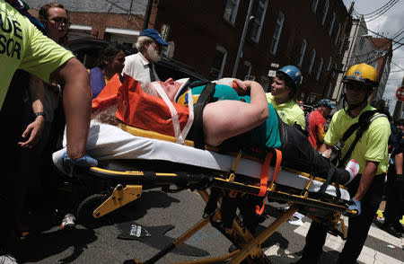 Rescue workers transport a victim who was injured when a car drove through a group of counter protesters at the "Unite the Right" rally Charlottesville. REUTERS/Justin Ide