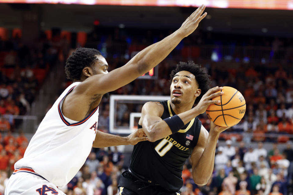 Vanderbilt guard Tyrin Lawrence (0) looks to shoot as Auburn forward Chris Moore (5) defends during the first half of an NCAA college basketball game, Wednesday, Jan. 31, 2024, in Auburn, Ala. (AP Photo/ Butch Dill)