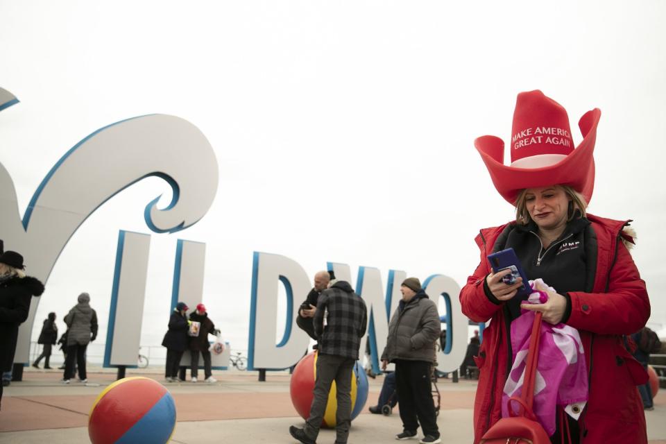 Laura Hess, 37, of Ridley Park, PA, wears a massive Make America Great Again hat before the start of a Keep America Great campaign rally in Wildwood, N.J., on Tuesday, Jan. 28, 2020. President Donald Trump will be holding the rally with Jeff Van Drew. (Heather Khalifa/The Philadelphia Inquirer via AP)