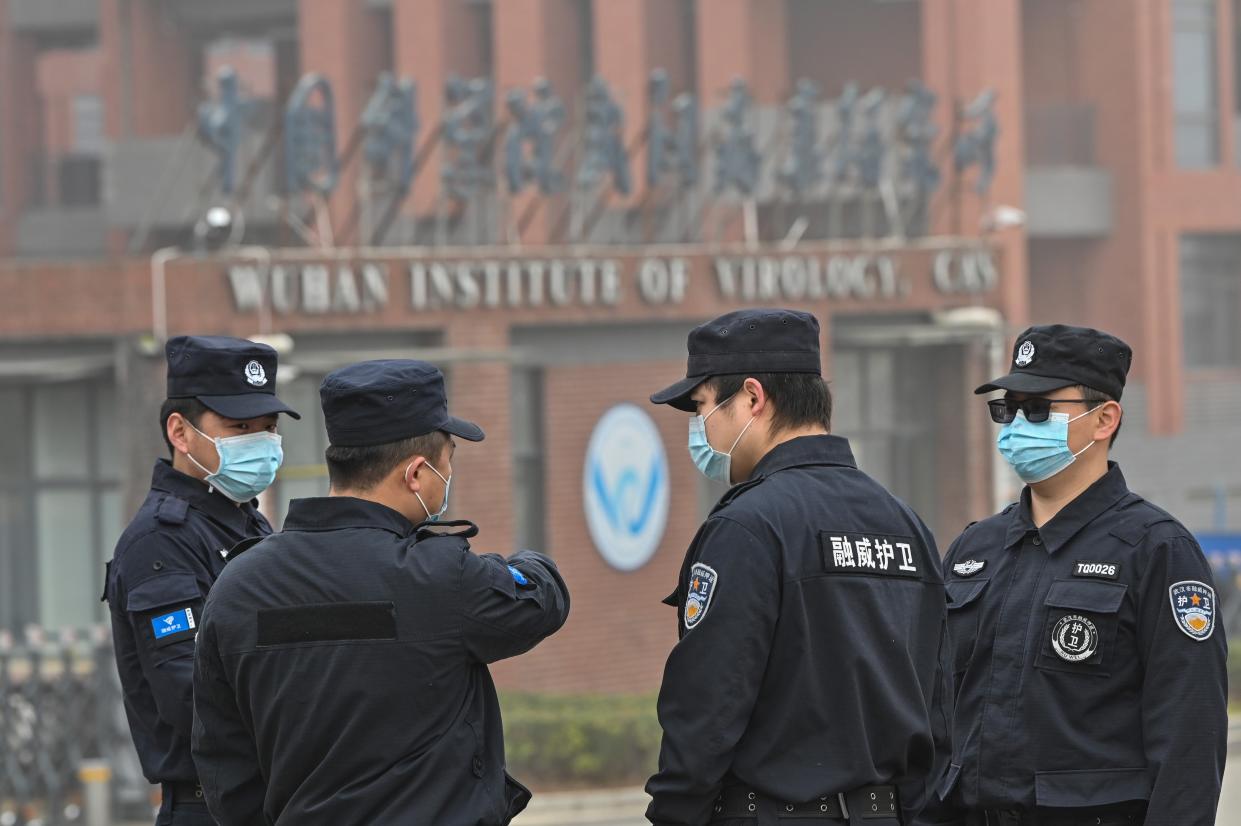 <p>Security personnel stand guard outside the Wuhan Institute of Virology in Wuhan as members of the World Health Organization (WHO) team investigating the origins of the COVID-19 coronavirus make a visit</p> (AFP via Getty Images)