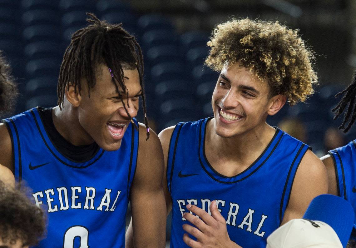 Federal Way’s Vaughn Weems (0) and Isaiah Afework (11) celebrate following the Eagles’ win over Mount Si in the third-fifth place game of the Class 4A boys state basketball tournament on Saturday, March 4, 2023 at the Tacoma Dome in Tacoma, Wash.