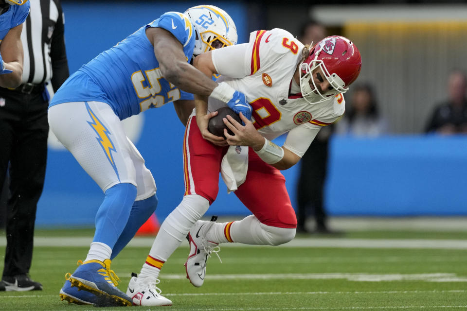Kansas City Chiefs quarterback Blaine Gabbert, right, is sacked by Los Angeles Chargers linebacker Khalil Mack during the first half of an NFL football game, Sunday, Jan. 7, 2024, in Inglewood, Calif. (AP Photo/Ashley Landis)