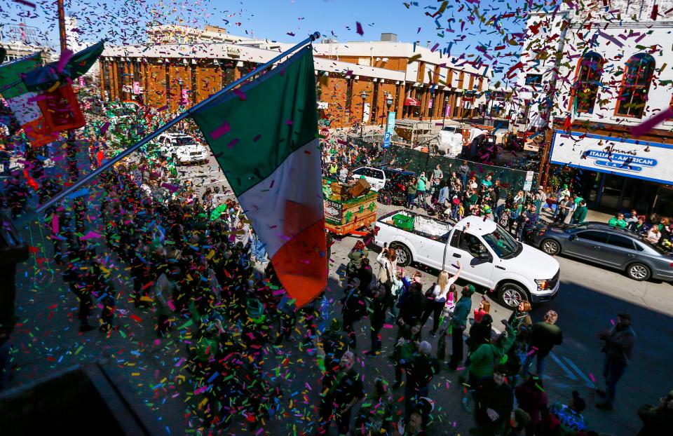 Confetti rains down from above Finnegan's Wake on parade goers along South Avenue during the St. Patrick's Day Parade on Saturday, March 16, 2019.