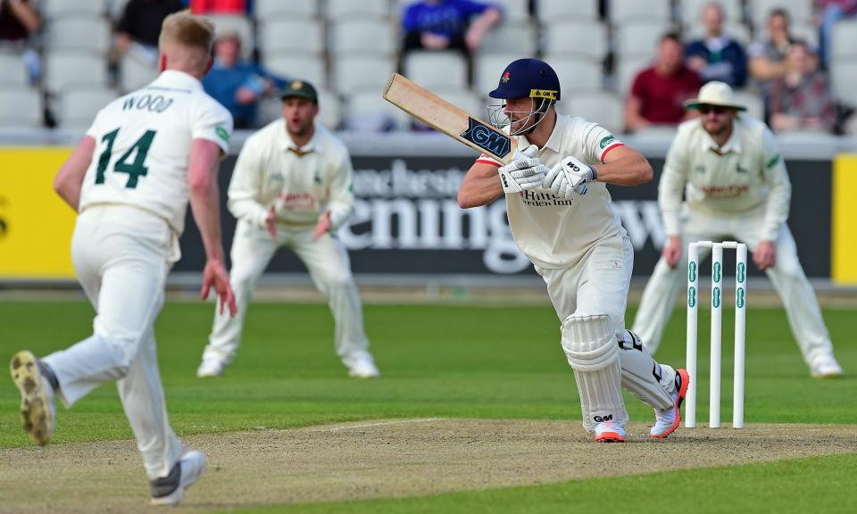 Lancashire’s Dane Vilas drives Nottinghamshire’s Luke Wood for four at Old Trafford.