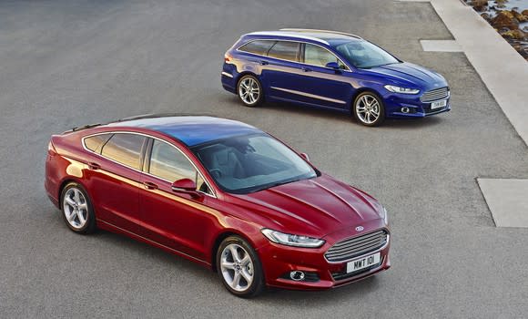 Two Ford Mondeos: A red five-door and a blue station wagon. Aside from the body-style changes, they look almost exactly like the Fusion sedan sold in the United States.