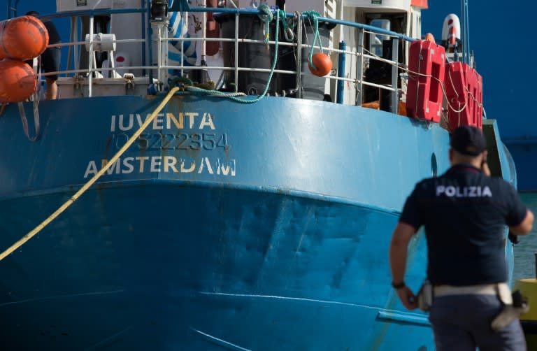 An Italian police officer stands by the Iuventa rescue ship run by German NGO Jugend Rettet (Youth Saves) (Bellina FRANCESCO)
