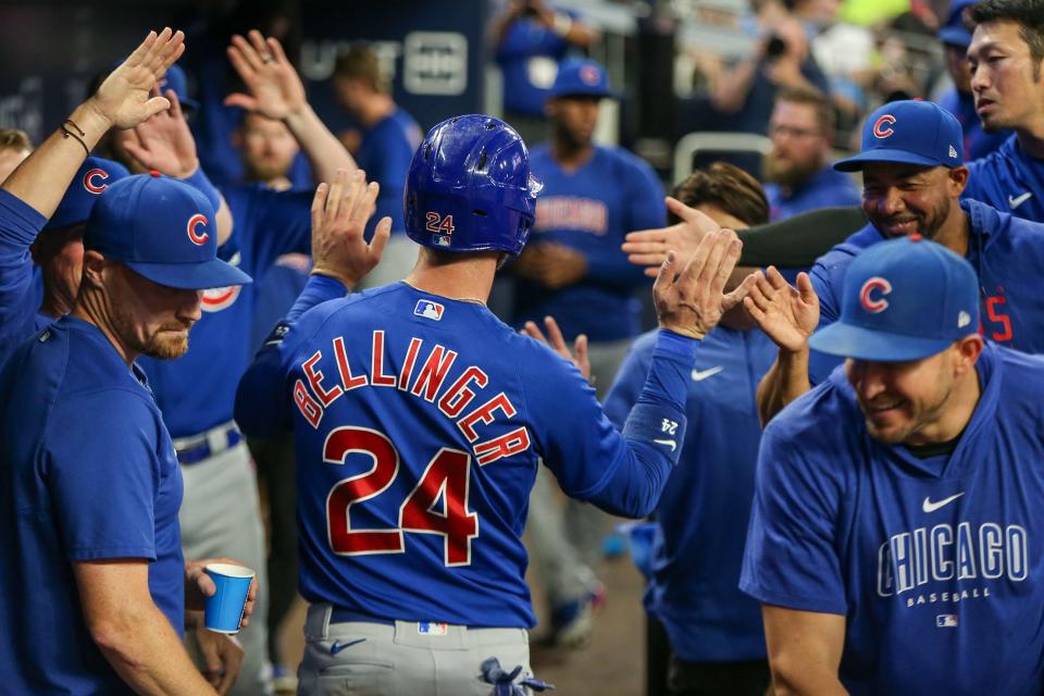 Chicago Cubs first baseman Cody Bellinger (24) celebrates with teammates after scoring a run against the Atlanta Braves in the second inning at Truist Park.