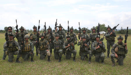 Members of the Philippine Marine Special Operation Group (MARSOG) pose for a picture before boarding a military truck during their send-off ceremony ending their combat duty against pro-Islamic State militant groups inside a military headquarters in Marawi city, southern Philippines October 21, 2017, a few days after President Rodrigo Duterte announced the liberation of Marawi city. REUTERS/Romeo Ranoco