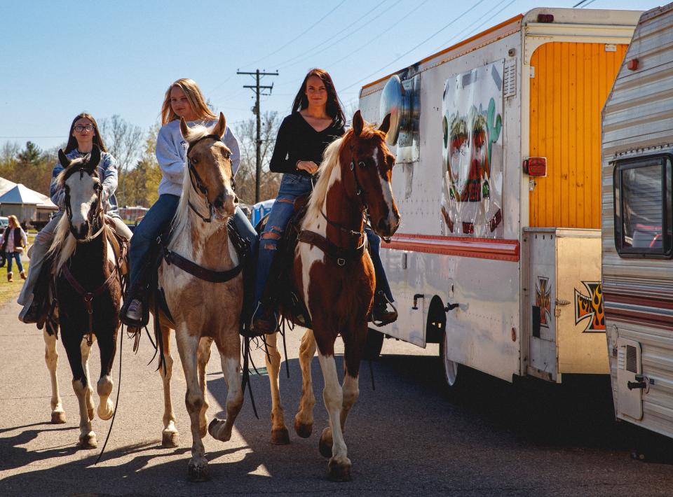 Three teenage girls on horseback ride around Maury County Park for Mule Day in Columbia, Tenn. on Mar. 29, 2023. Mule Day is an annual event in its 49th year that celebrates Columbia's history as a world renowned mule trading post.