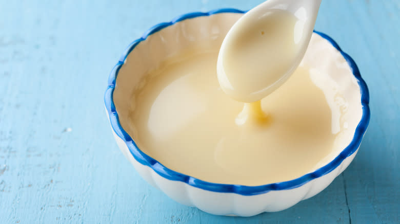 bowl of condensed milk and spoon