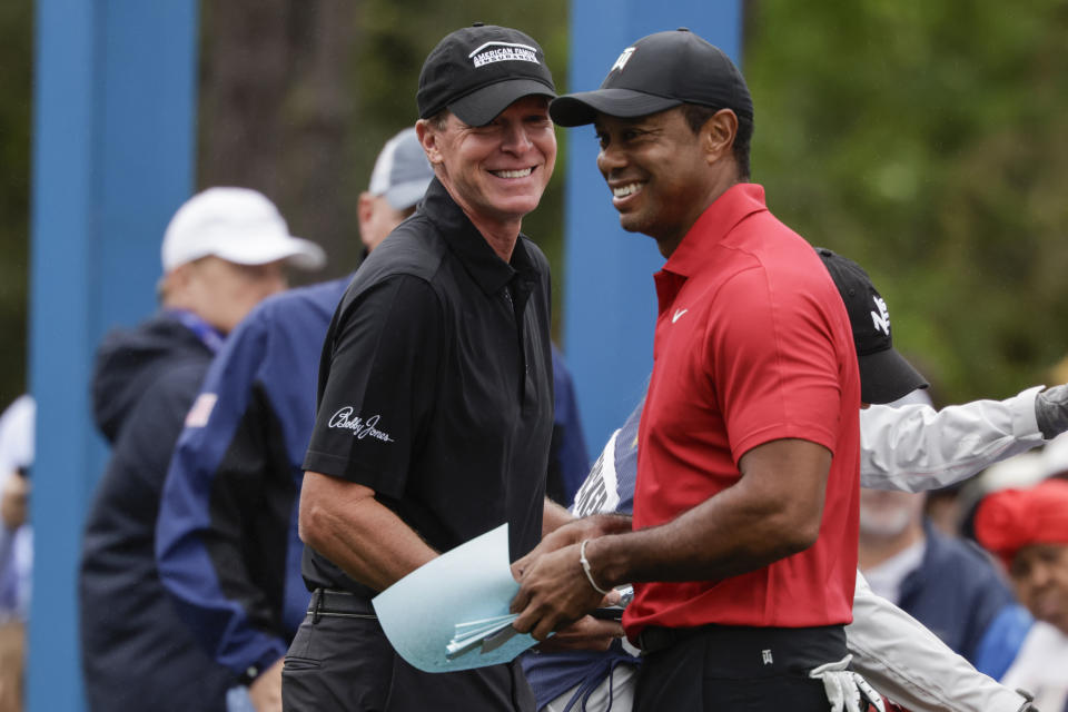 Tiger Woods, right, and Steve Stricker, left, laugh before teeing off during the final round of the PNC Championship golf tournament Sunday, Dec. 17, 2023, in Orlando, Fla. (AP Photo/Kevin Kolczynski)