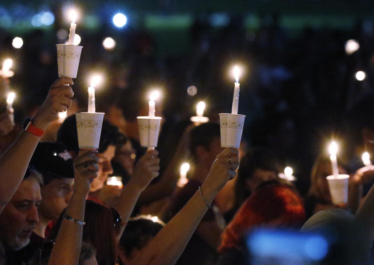 Candles at one of the vigils honouring the victims at Stoneman High: AP