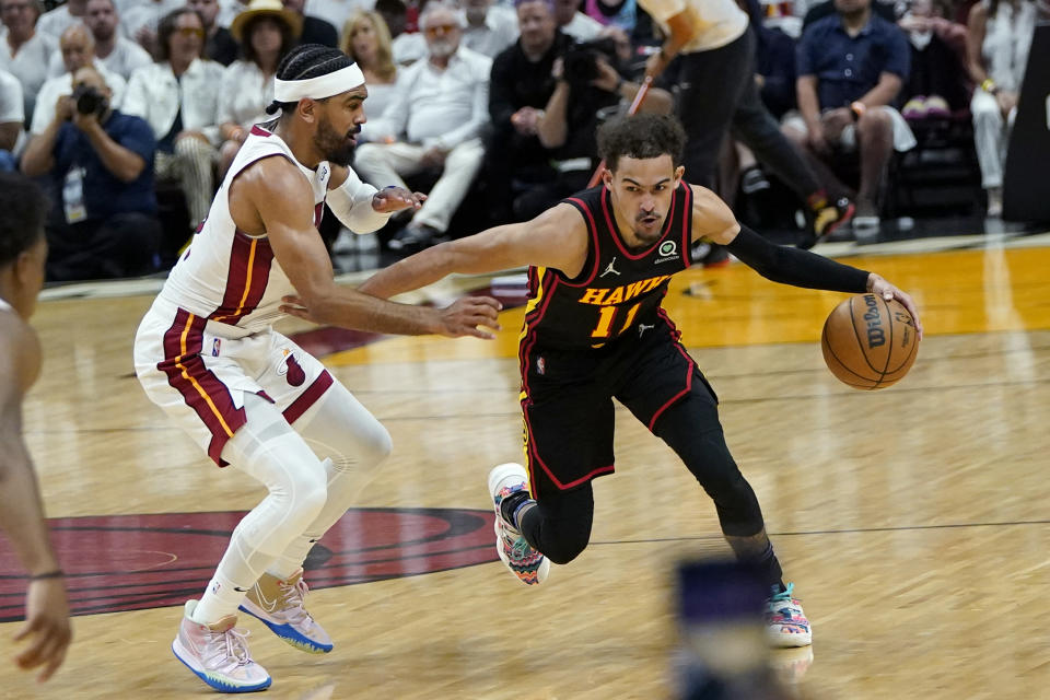 Atlanta Hawks guard Trae Young (11) drives to the basket as Miami Heat guard Gabe Vincent defends during the first half of Game 1 of an NBA basketball first-round playoff series, Sunday, April 17, 2022, in Miami. (AP Photo/Lynne Sladky)
