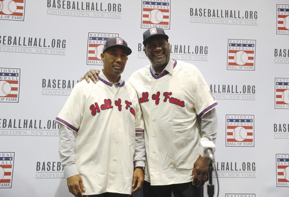 FILE - In this Dec. 10, 2018, file photo, Harold Baines, left, and Lee Smith pose during a news conference for the Baseball Hall of Fame during the Major League Baseball winter meetings in Las Vegas. Baseball Hall of Fame induction ceremonies are Sunday, July 21, 2019, in Cooperstown, N.Y. .(AP Photo/John Locher, File)