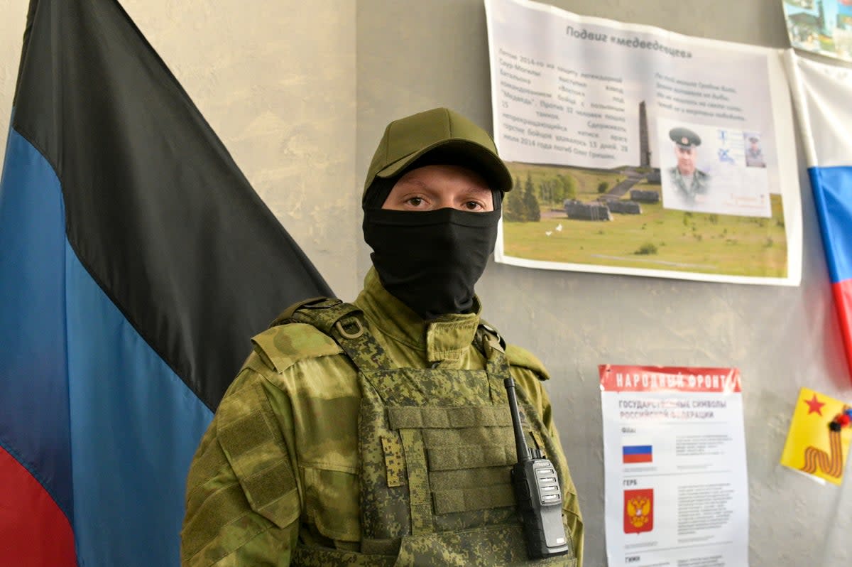 A Russian separatist guard at a polling station as voters take part in referenda dismissed by Western leaders as a ‘sham.  (AP)