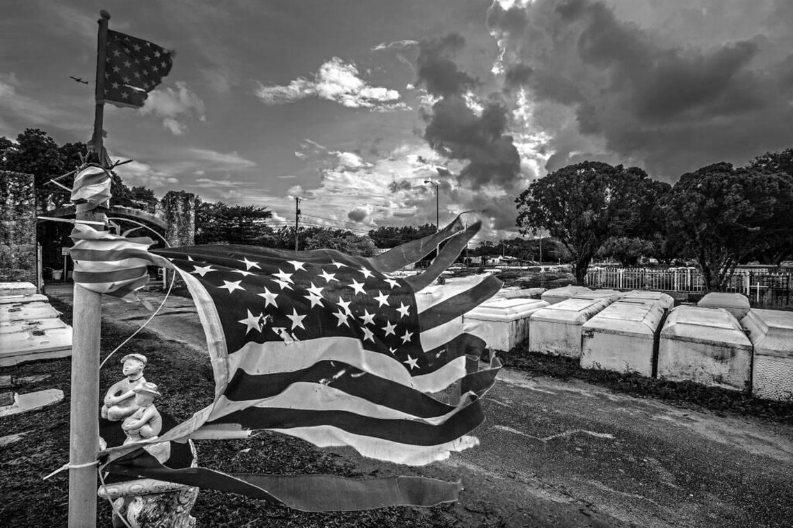 In “Frayed Glory,” a weathered American flag still waves above the graves at Lincoln Memorial Park cemetery.