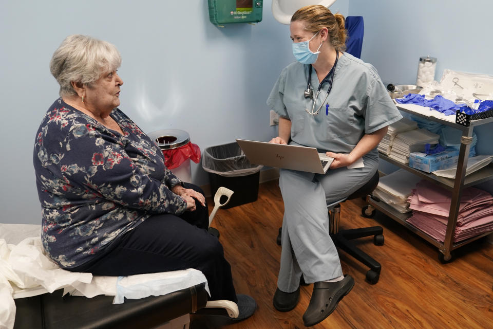 Dr. Catherine Casto, right, talks with Catherine Burns, left, of Millsboro, Del., during a visit to a Chesapeake Health Care office in Salisbury, Md., Thursday, March 2, 2023. Burns has been seeing Dr. Casto for 25 years. (AP Photo/Susan Walsh)
