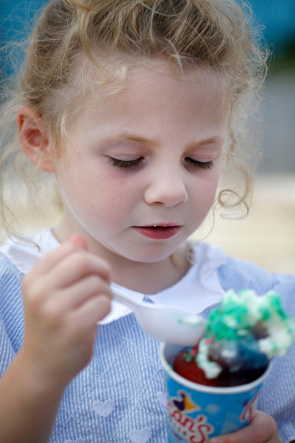 Addie Coppenrath, 5, enjoys a Unicorn shaved ice at Pelican's SnoBalls in Brant Rock on Thursday, Aug. 18, 2022.