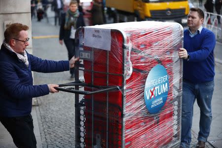 Workers unload ballot papers of the voting for a possible coalition between the Social Democratic Party (SPD) and the Christian Democratic Union (CDU) to the SPD headquarters in Berlin, Germany March 3, 2018. REUTERS/Hannibal Hanschke