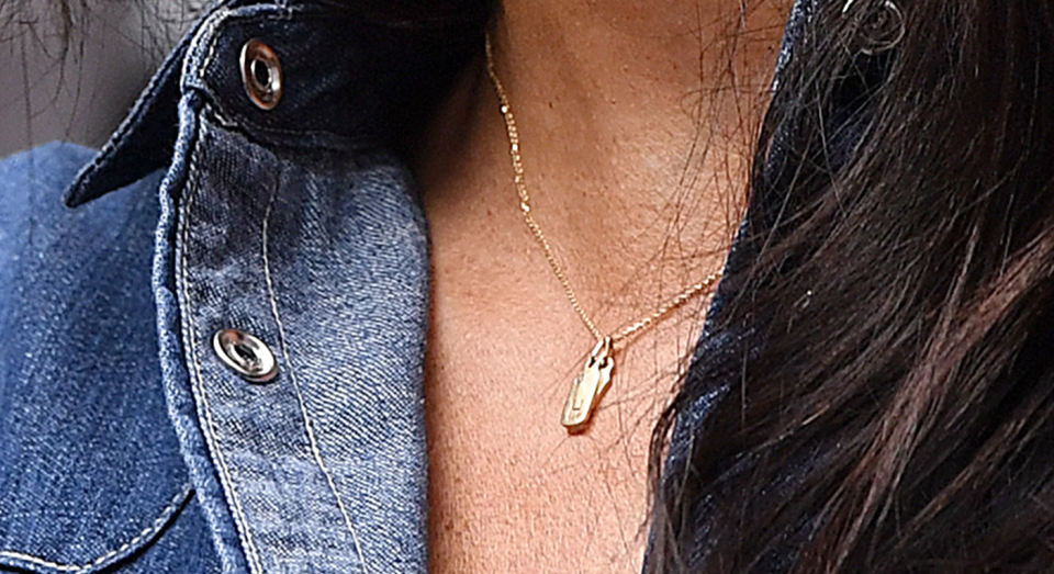 Meghan wore two dog tag charms by Mini Mini Jewels [Photo: Getty Images]