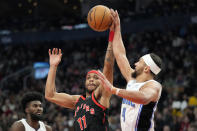 Toronto Raptors forward Bruce Brown (11) and Orlando Magic guard Jalen Suggs (4) vie for control of the ball during the first half of an NBA basketball game Friday, March 15, 2024, in Toronto. (Frank Gunn/The Canadian Press via AP)