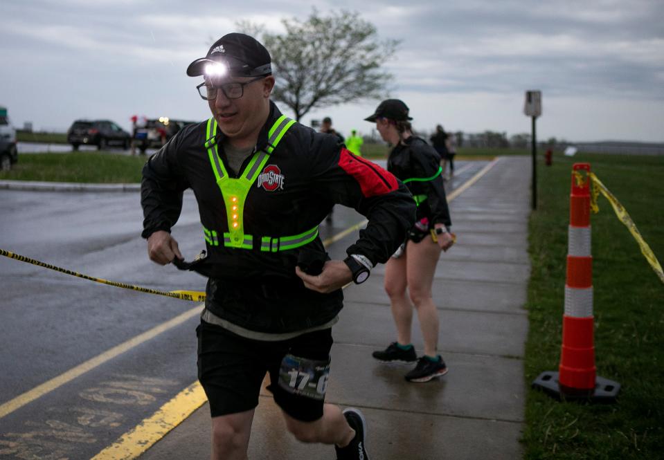 Runners hand off batons and rest up during The Buck Fifty Race at one of the checkpoints at Adena High School on April 21, 2023 in Frankfort, Ohio.