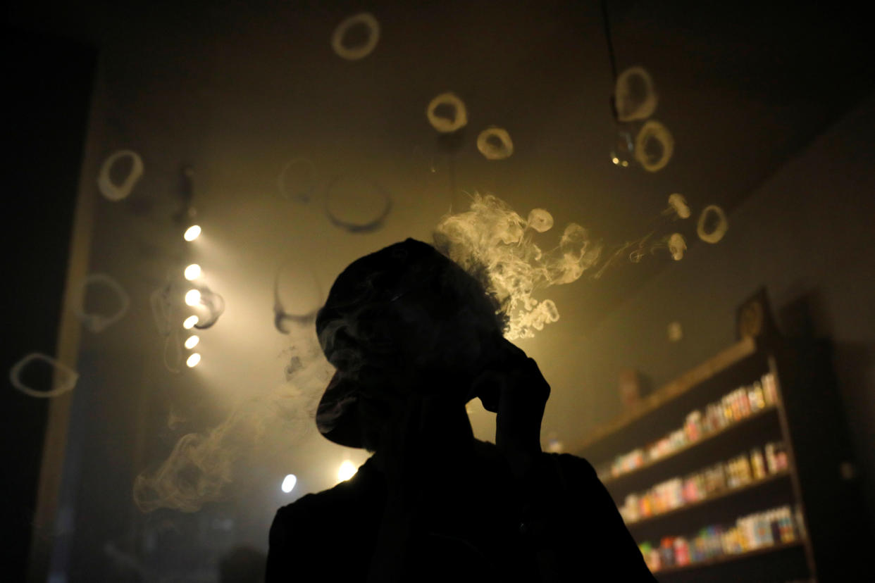 A man blows smoke rings at Gerobak Vapor vapeshop in Jakarta, Indonesia, February 2, 2019. REUTERS/Willy Kurniawan