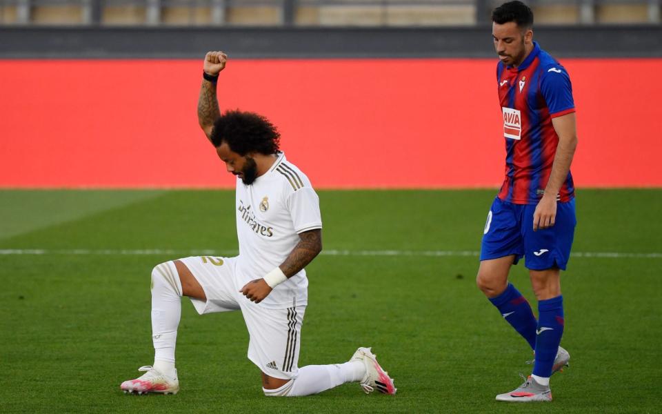 Real Madrid's Brazilian defender Marcelo kneels on the field to celebrate his goal during the Spanish League football match between Real Madrid CF and SD Eibar  - PIERRE-PHILIPPE MARCOU/AFP via Getty Images