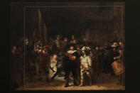 A photograph with lines showing the added parts explains how Rembrandt's biggest painting the Night Watch just got bigger with the help of artificial intelligence in Amsterdam, Netherlands, Wednesday, June 23, 2021. The Dutch national museum and art gallery reveals findings from a long-term project to examine in minute detail Rembrandt van Rijn's masterpiece the Night Watch.(AP Photo/Peter Dejong)