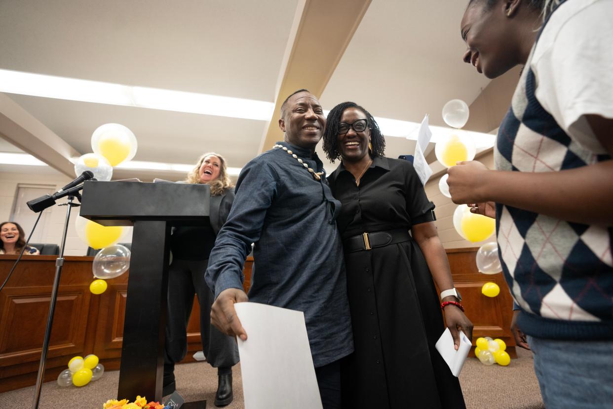 Mar 9, 2024; Haworth, NJ, USA; (Center) Omoyele Sowore hugs his wife Opeyemi Oluwole-Sowore during a homecoming celebration for him at Haworth Borough Hall. (Right) Their daughter Ayomide looks on. Omoyele Sowore, a Nigerian citizen, political activist, and journalist, who lives with his wife, son and daughter in Haworth, was detained by Nigerian authorities and imprisoned after he returned to his homeland.