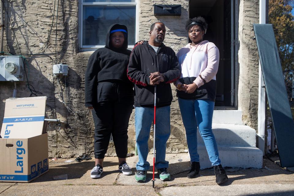 William Murphy, center, stands for a portrait with his daughters Aaliyah, left, and Kylah in front of their former home on Townsend Street on Feb. 24, 2021, in Wilmington.
