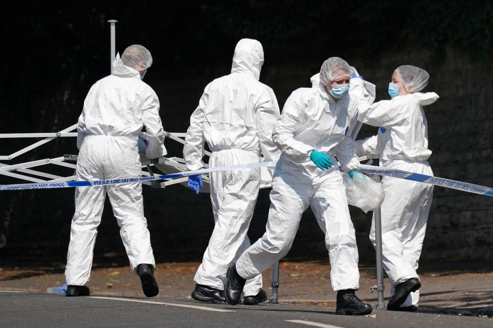 Police forensics officers on Magdala road, Nottingham (PA)
