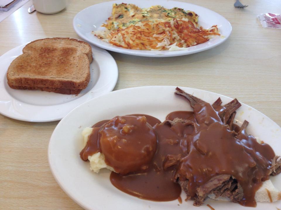 Roast beef, gravy and mashed potatoes on bread and a spinach and feta cheese omelet at the Washington Family Restaurant.