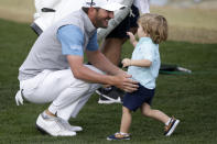 Andrew Landry, left, greets his son, Brooks Landry, on the 18th hole after winning The American Express golf tournament on the Stadium Course at PGA West in La Quinta, Calif., Sunday, Jan. 19, 2020. (AP Photo/Alex Gallardo)