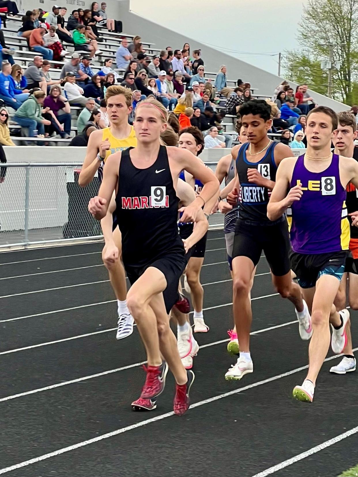 Marion Harding's Carter Ferguson leads the pack during the first lap of the boys 1600 meters at Friday's Marion Night Invitational at Harding Stadium.