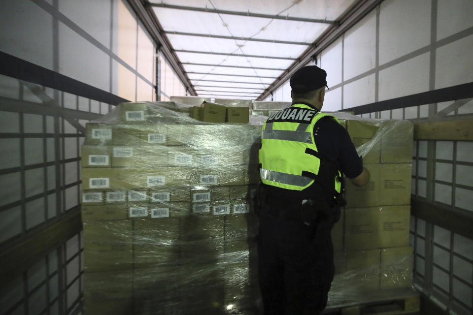 A French custom officer checks a truck coming from Britain's port of Portsmouth at the transit zone at the port of Ouistreham, Normandy, Thursday, Sept.12, 2019. France has trained 600 new customs officers and built extra parking lots arounds its ports to hold vehicles that will have to go through extra checks if there is no agreement ahead of Britain's exit from the EU, currently scheduled on Oct. 31. (AP Photo/David Vincent)