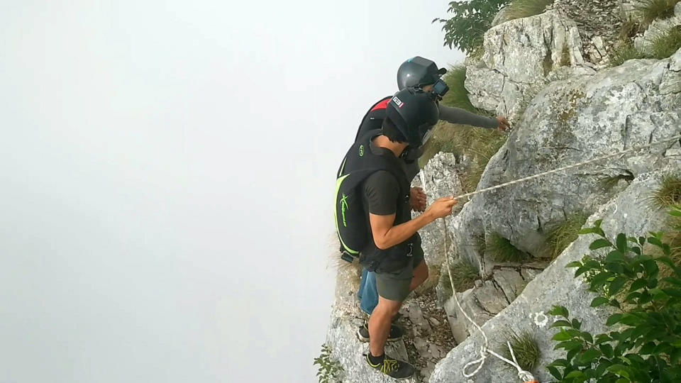 These friends filmed themselves freefalling backwards from a cliff - while holding hands. Josephine Eve, 28, and Niclas Strohmeier, 23, performed the stunt at the BASE jumping hotspot of Monte Brento, Italy. They fall backwards into the dense mist below before separating in the air and landing safely.