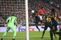 Benfica's Joao Felix, center, jumps for the ball with Galatasaray midfielder Badou Ndiaye during the Europa League round of 32, second leg, soccer match between Benfica and Galatasaray at the Luz stadium in Lisbon, Thursday, Feb. 21, 2019. (AP Photo/Armando Franca)